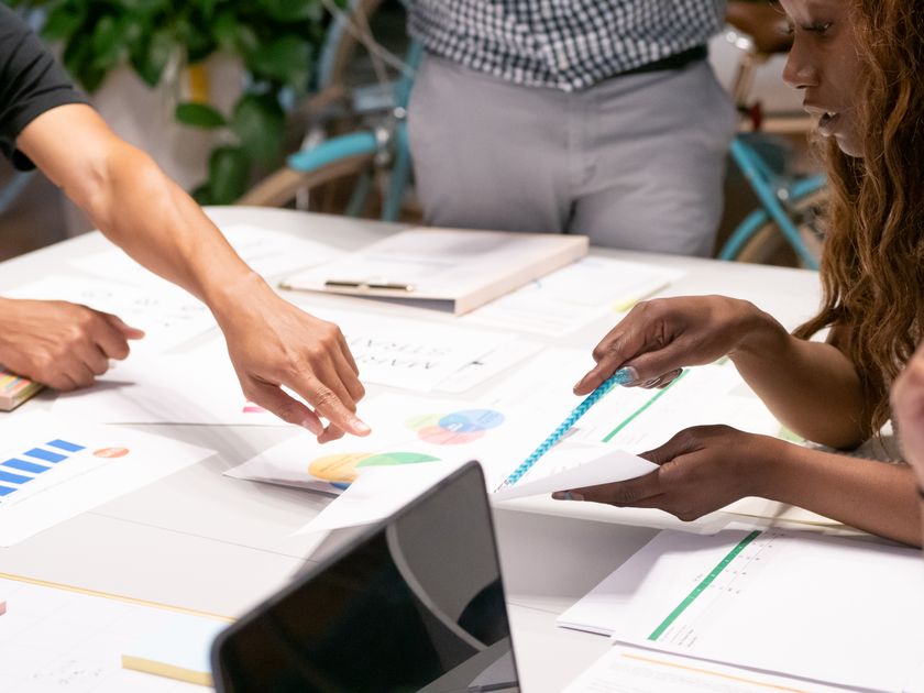A marketing team collaborating around analytics during a strategy session.
