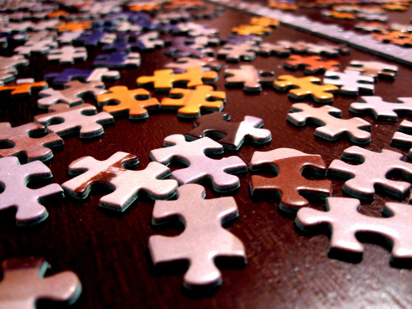 Assorted puzzle pieces, a metaphor for browser extensions snapping into place around an AI assistant.