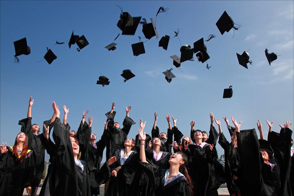 Graduates tossing their caps, evoking the many roles a persona prompt can invoke.