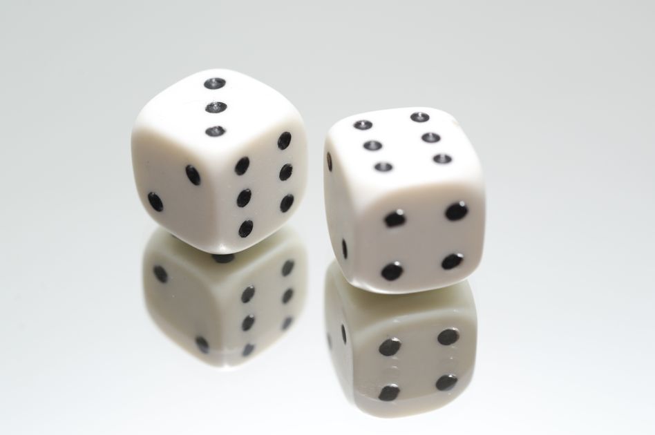A pair of dice on a mirror, symbolizing the randomness behind varying AI answers.